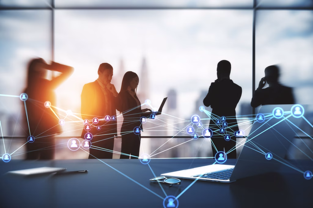 Businesspeople Working Together In Modern Office With Laptop On Desktop And Abstract Glowing