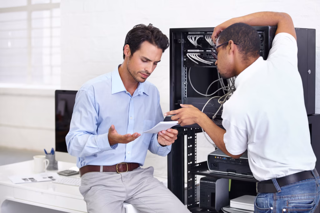 It specialist helping with hardware to a businessman