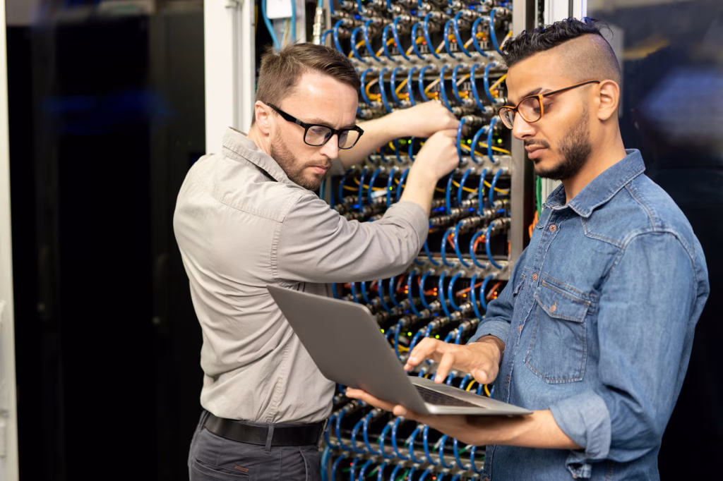 Remove background 1 Expand 1 Describe your changes Engineers Working on Servers in a Data Center