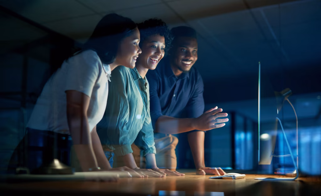 Excited Team Collaborating on a Project at Night