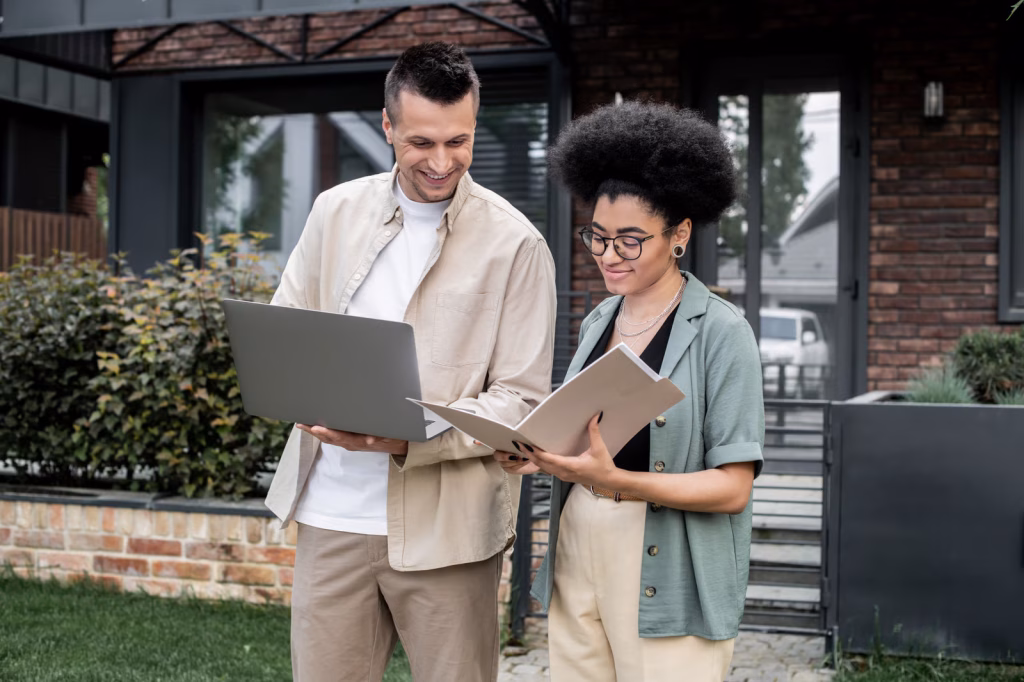 Cheerful Colleagues Work Together Outside a Modern House