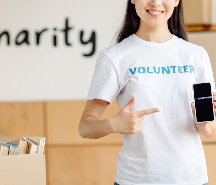 A woman who works for a nonprofit organization showing the Krove logo on her cell phone